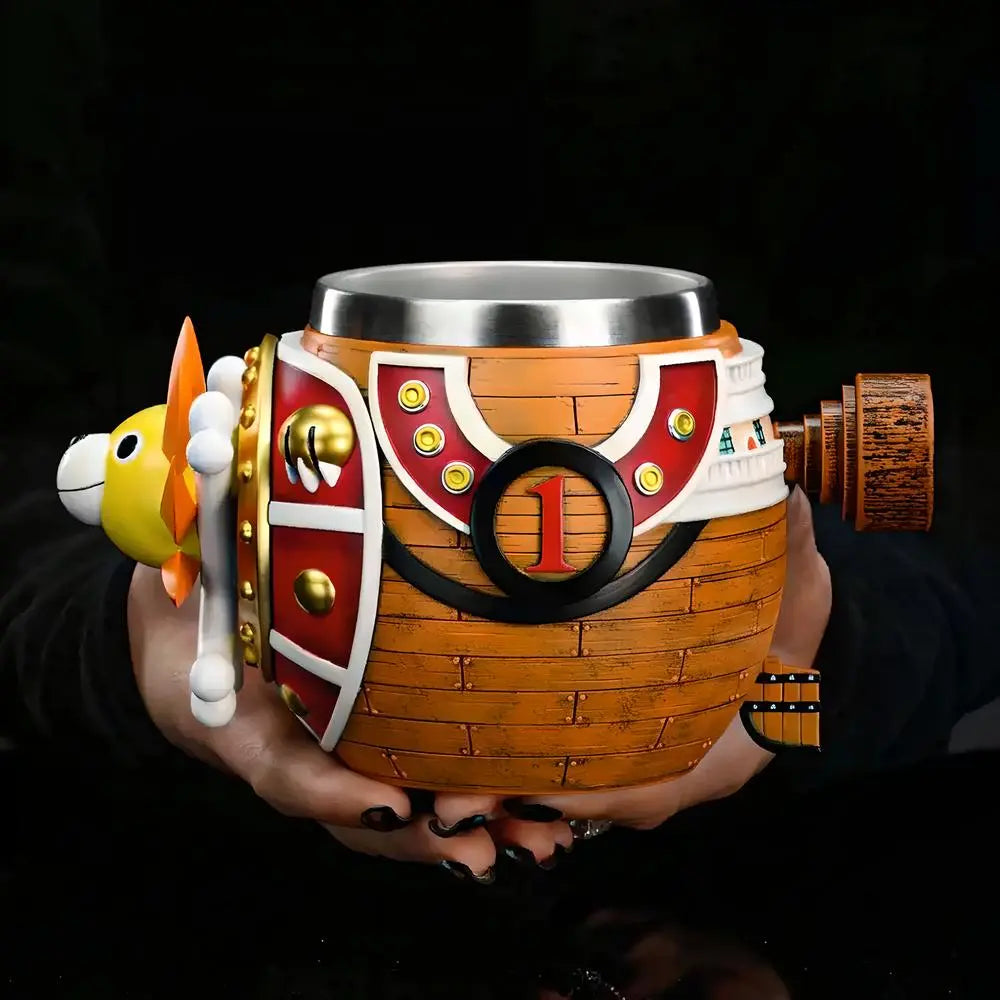 Close-up of a hand holding the One Piece Thousand Sunny barrel tankard, showing hull number 1 and ship details against black background