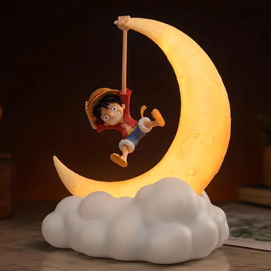 A Luffy figure in a dynamic pose on a glowing crescent moon lamp