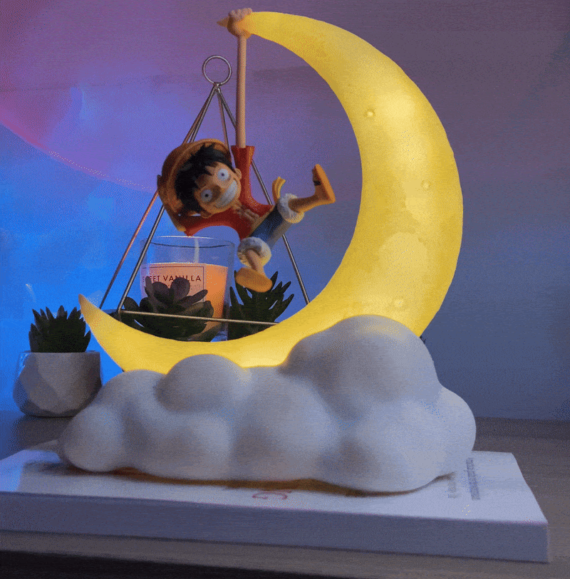 An animated showcase of the One Piece Luffy Gear 5 crescent moon lamp, displaying the warm ambient light against changing background hues, resting on a book for room decor