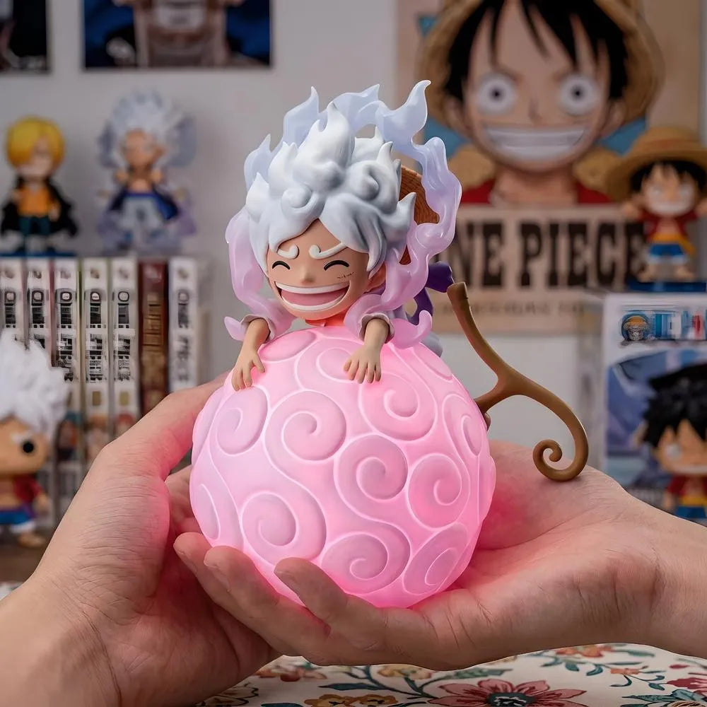 One Piece Luffy Gear 5 Sun God Nika Devil Fruit night light held in hands with manga books background
