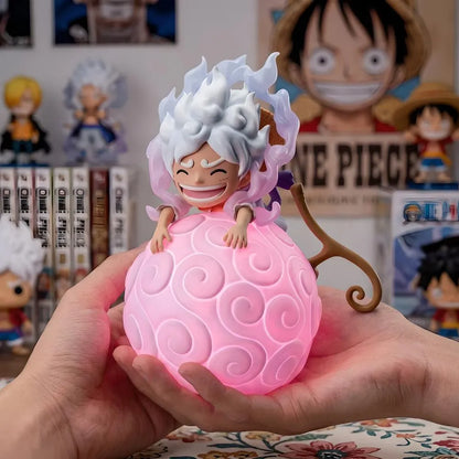 One Piece Luffy Gear 5 Sun God Nika Devil Fruit night light held in hands with manga books background