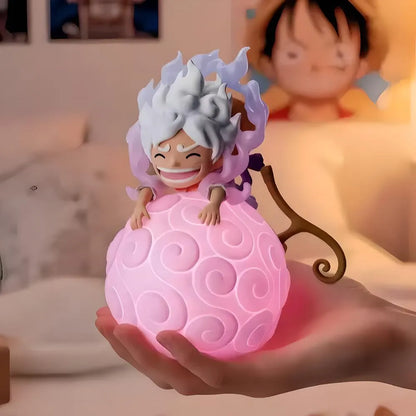 Glowing pink Devil Fruit night light featuring Gear 5 Luffy held in hand for cozy bedroom decor